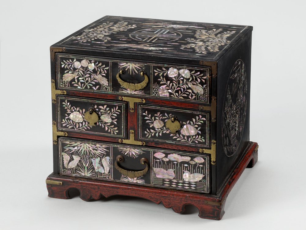 Black lacquer chest of drawers inlaid with mother-of-pearl birds, flowers and a longevity character